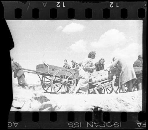Residents pulling two hearses through the ghetto
