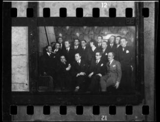 Group portrait of well dressed men and a woman