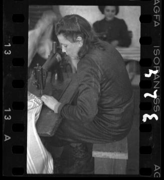 A young woman sewing in the Holzwollefabrik workshop ("ressort") in the ghetto