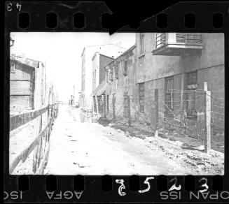 Ghetto street with barbed wire fence