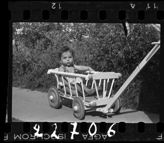 Portrait of a child in a wagon