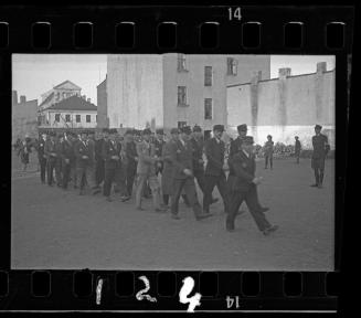 Jewish policemen marching through the ghetto