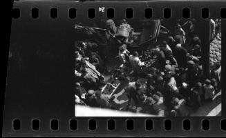 A corpse carried through a crowd of residents in the ghetto