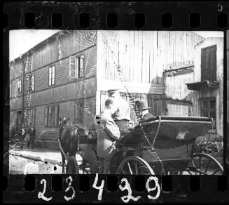 Two men talking in a carriage in the ghetto