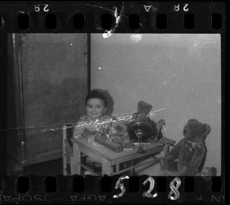 Portrait of a young child with toys