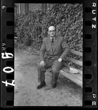 Male ghetto resident seated on a bench