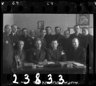Group portrait of members of the ghetto administration in an office