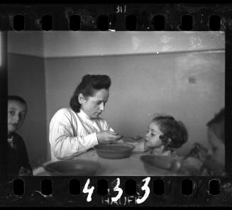 A nurse feeding children in an orphanage