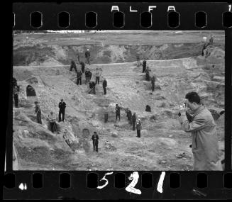Mendel Grossman photographing the excavation of a central cesspit, dug at the end of Francizkanska Street in 1941, supervised by Jewish policemen
