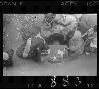 Residents sorting through the belongings of deported residents from the ghetto