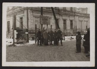 Lodz Ghetto liberated, residents standing freely at restricted Juden gate