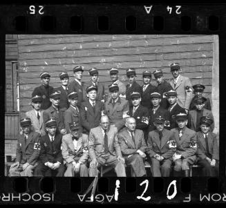 Group portrait of Jewish policeman and a member of the Transport Department outside an unidentified building