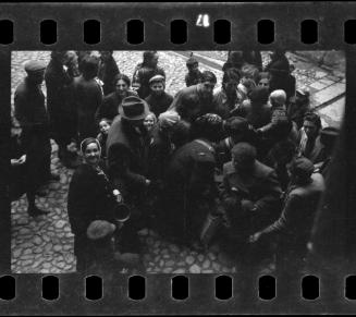 Postal worker surrounded by residents in the ghetto