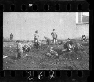 Children searching  in the ground for waste food, coal and wood