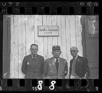 Jewish policeman and administrators standing outside a warehouse for potatoes and vegetables in Marysin