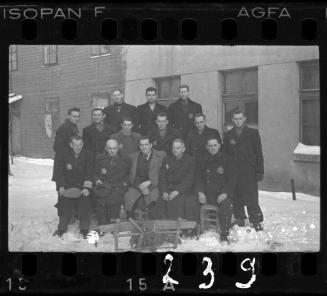 Group portrait of Jewish men in the ghetto in winter