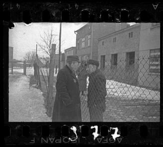 Men talking through prison fence