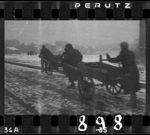 People pulling empty wagons