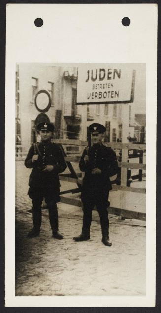 German officials, standing under 'Juden Betreten Verboten' sign [Jews, entry forbidden]