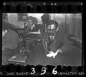 Man sewing fabric in a workshop ("ressort") in the ghetto