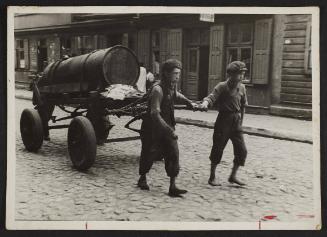 Young boys hauling a cart, Lodz Ghetto [Arie Lejb Kasiarz as young boy, left side]