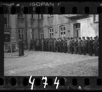 Jewish policemen standing in a line in a courtyard