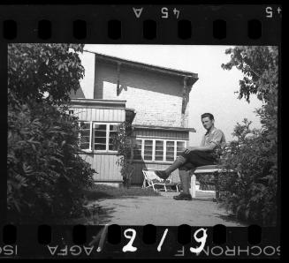 Ghetto policeman sitting in a courtyard