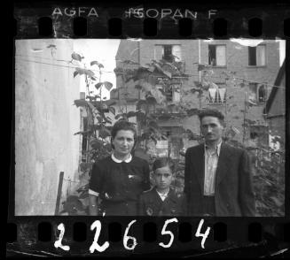 Family with a boy against tall ghetto building