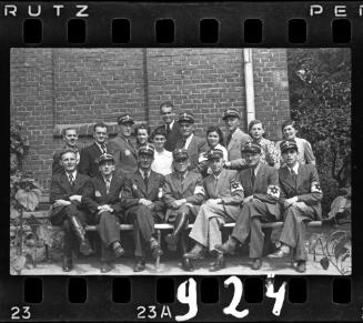 Group portrait of Jewish policemen and four unidentified women in the ghetto