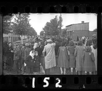 Ghetto residents talking through the fence of the central prison prior to deportation