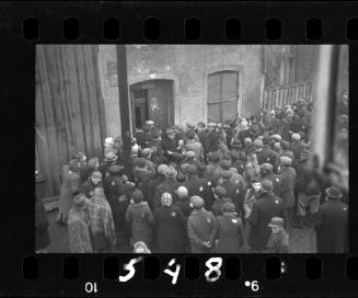 Residents gathered outside the doorway of building #44 in the ghetto