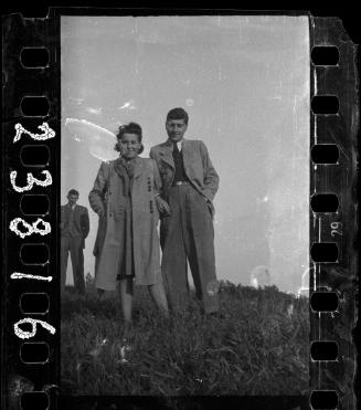 A couple with hands in their pockets