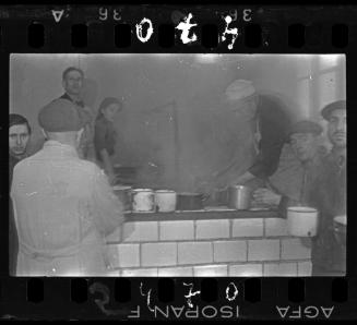 Man ladling soup in the kitchen