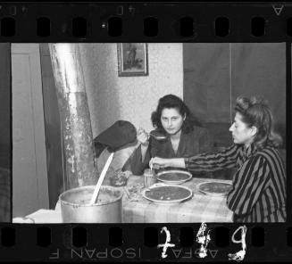 Stefania Schoenberg (right) and her friend, sitting at a table eating soup