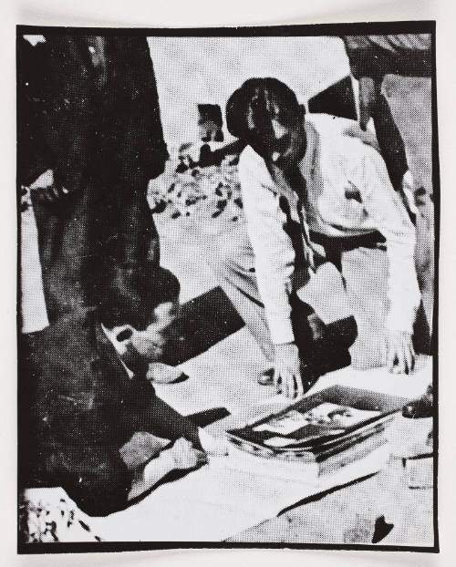 Henryk Ross and unknown man looking at photographs