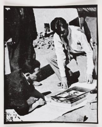 Henryk Ross and unknown man looking at photographs