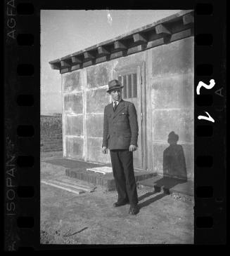 Portrait of an official near workers digging trenches