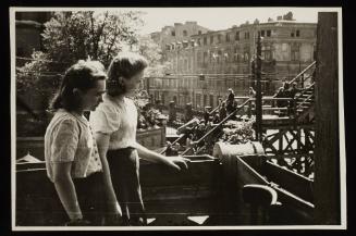 Two young women observing the bridge at Koscielyn Square, crossing Zigerska Street