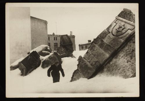 Man walking in winter in the remains of the synagogue on Wolborska Street, destroyed by the Germans in 1939