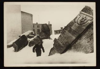 Man walking in winter in the remains of the synagogue on Wolborska Street, destroyed by the Germans in 1939