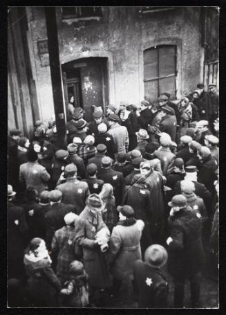 Residents gathered outside the doorway of building #44 in the ghetto