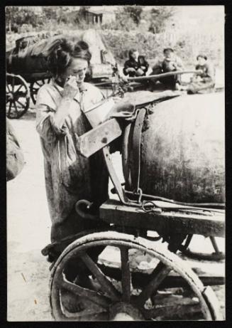 Female fecal worker eating out of pail