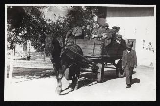 Man walking alongside horse-drawn deportation wagon carrying residents being deported from the ghetto