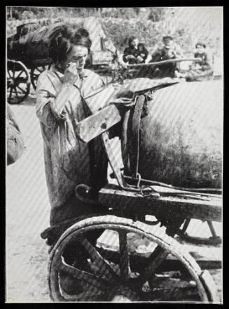 Female fecal worker standing and eating from pail