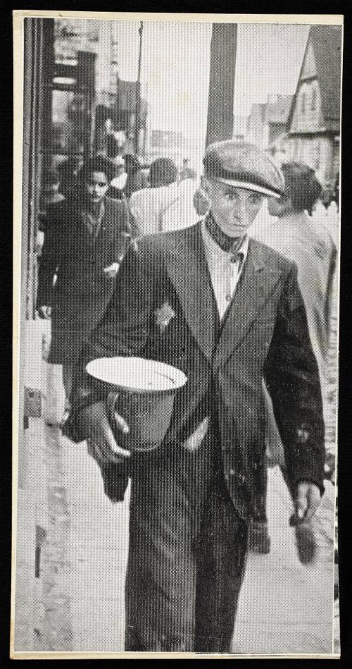 Hungry man walking on street with pail and empty plate