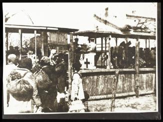 A woman being helped into the deportation train at Radogoszcz Station