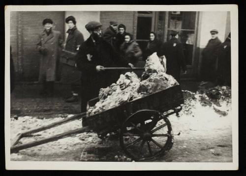 Man shovelling snow onto cart