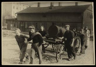 Two women pulling fecal cart