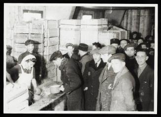 Cook ladling soup into pails for residents