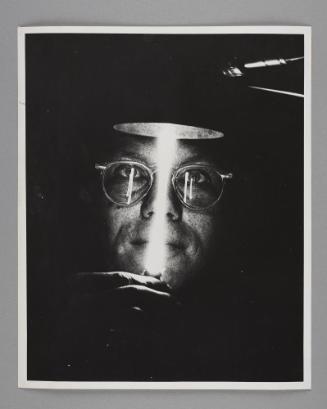 Science Works for Consumers: A scientist from the Oak Ridge National Laboratory holds a lamp devised to measure the smallest distances